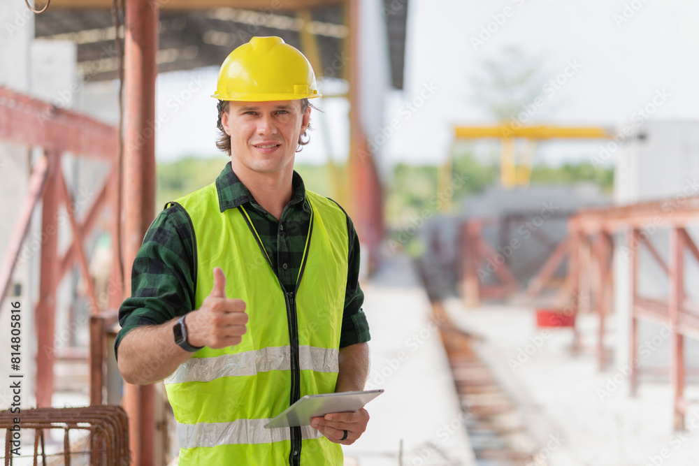 Happy engineer man with doing thumbs up gesture, Cheerful foreman worker with digital tablet on a construction site Happy engineer man with doing thumbs up gesture, Cheerful foreman worker with digital tablet on a construction site