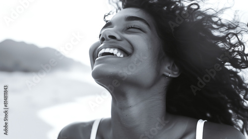 A Brazilian girl as she feels the refreshing ocean breeze against her skin