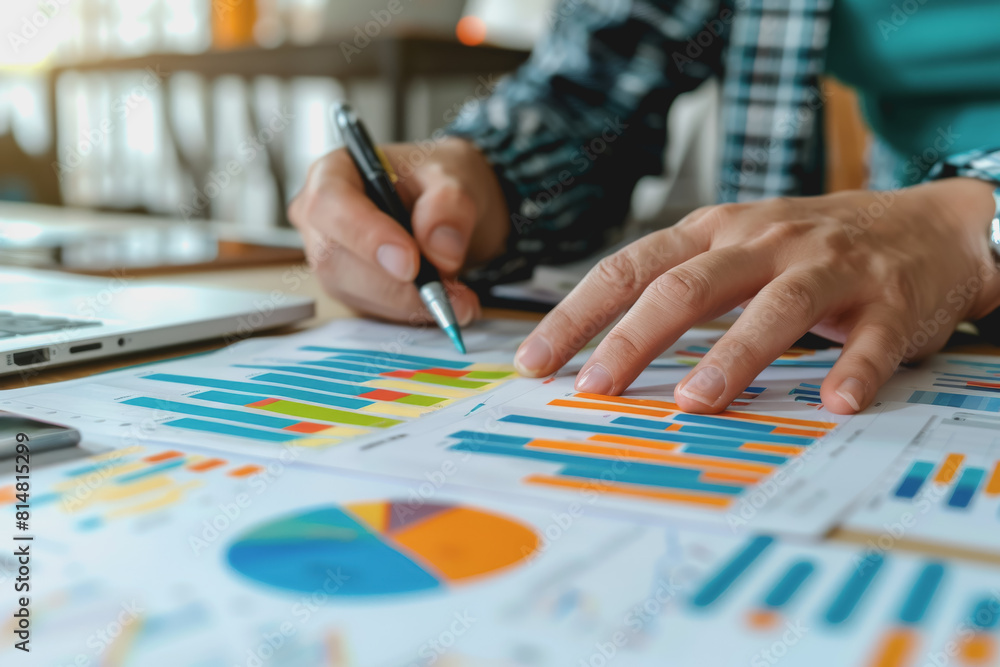 Hands business team having a meeting to analyze data graph charts for a marketing plan. Hands business team having a meeting to analyze data graph charts for a marketing plan.