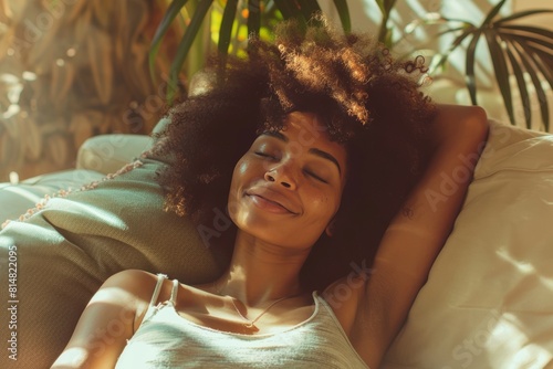 Smiling afro american woman relaxing on sofa at home, healthy life style and good vibes concept photo