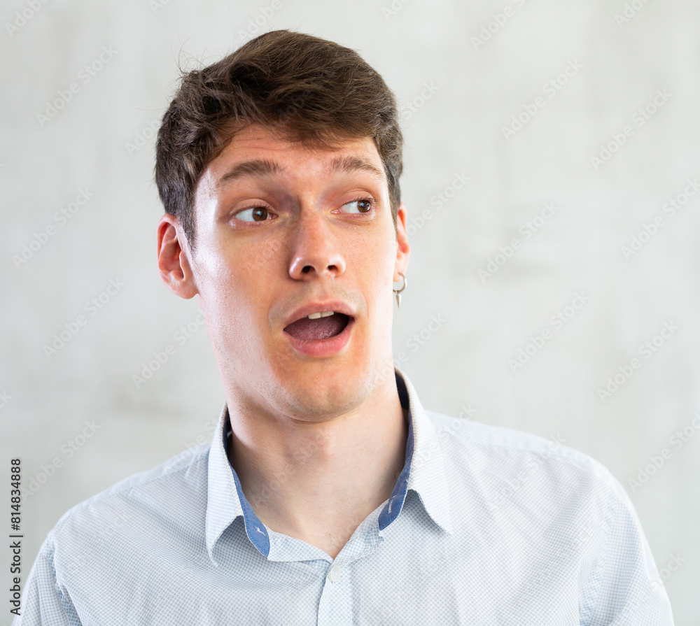 Obraz premium Emotions, people and positive concept man expresses different on gray background
