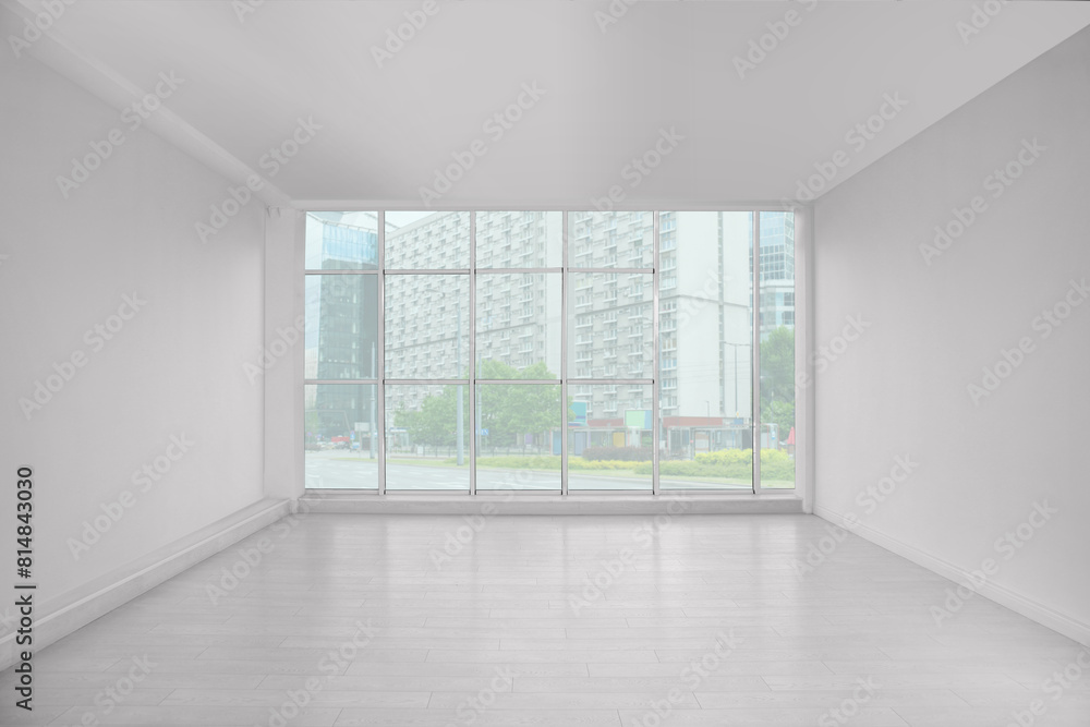 Fototapeta premium Empty room with large window and laminated floor