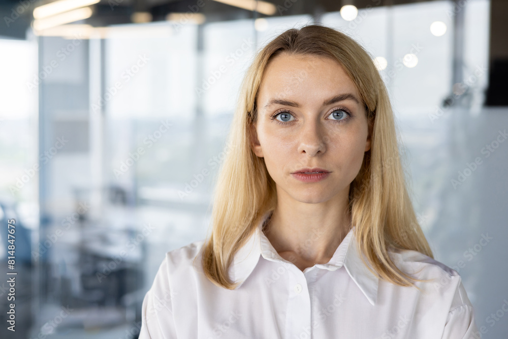 Confident businesswoman in modern office looking directly at the camera Confident businesswoman in modern office looking directly at the camera