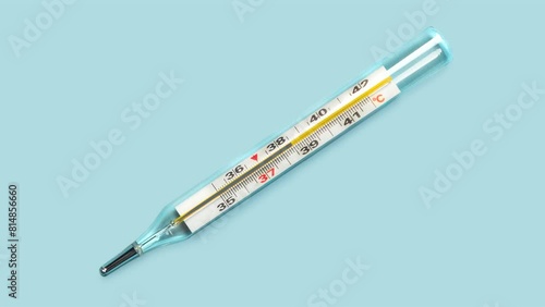 Mercury-in-glass thermometer with temperature mark 39 on blue background flat lay stopmotion animation slow motion video 4k photo