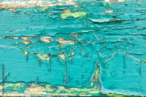 Old turquoise peeeling paint background, blue painted weathered wood texture photo