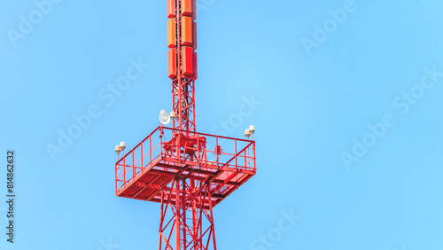 Communication tower close-up. 5G Telecommunications Base Station Tower. Mobile communication tower on the background of the sky. Antenna repeater cell tower in city. Concept GPS, cellphone, 3G, 4G.