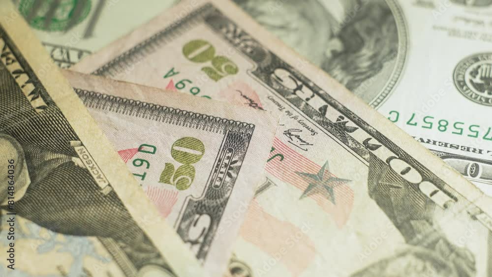 Money in different dollar bills revolve on table. Close-up. Cash banknotes close up view. Stack of money. Dollars Bills. Business, inflation and deflation concept. Finance money background Money in different dollar bills revolve on table. Close-up. Cash banknotes close up view. Stack of money. Dollars Bills. Business, inflation and deflation concept. Finance money background