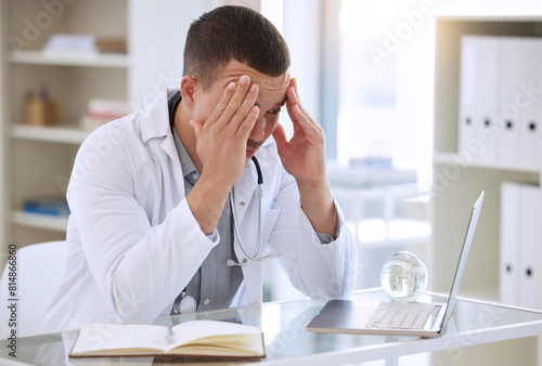 Doctor, frustrated and man in clinic with laptop for surgery mistake, headache pain and test results for cancer. Male surgeon, stress and tech at desk with 404 glitch for online article and brain fog