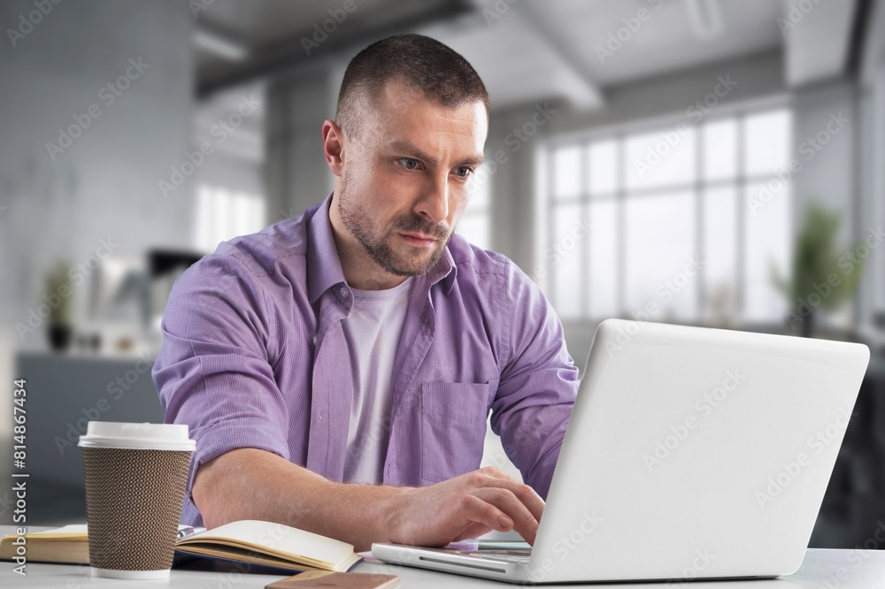 Fototapeta premium Young successful businessman at workplace office