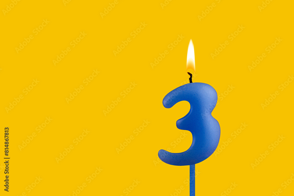 Blue candle number 3 - Birthday on yellow background Blue candle number 3 - Birthday on yellow background