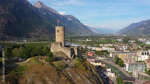 Martigny, Switzerland: Aerial drone footage of the Bâtiaz medieval fort overlooking Martigny city in Canton Valais in the Swiss alps. photo