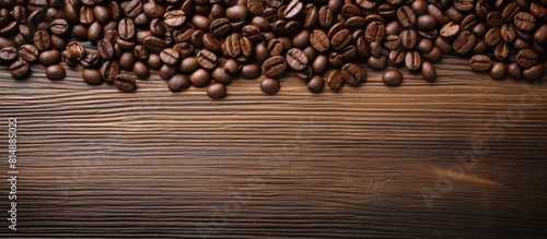 Coffee grains are arranged on a wooden table creating a copy space image