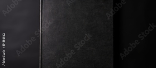 A black notebook placed close up on a white background with copy space for adding text It represents literature reading writing and leisure time with books
