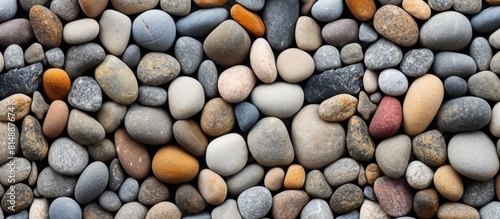 Copy space image of small smooth rounded rock pebbles providing a textured background for adding text