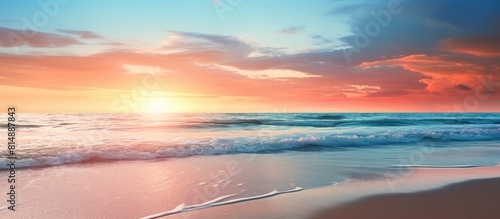 A beautiful beach with the setting sun reflecting on the calm glistening sea Copy space image