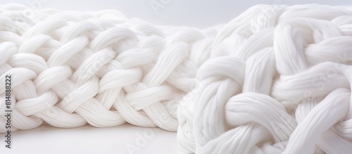 A white background showcasing a knitted textile and wool yarn with copy space image