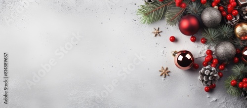 A Christmas themed design featuring various festive decorations and a blank paper mockup with copy space on a textured gray linen background