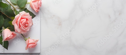 Top view of a floral greeting card featuring a pink rose frame on a gray background The image is laid out flat with copy space