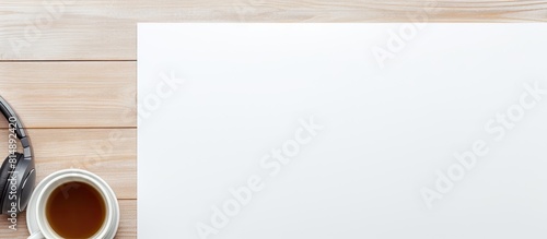 The white table is equipped with a wireless headphone notebook and pencil holder From a top view there is available copy space for text