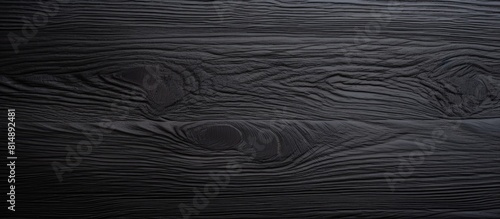 A black wooden blank with a textured surface serves as a background for design purposes providing ample copy space image