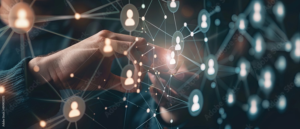 Businessman touching icons representing social networks and human resources on a virtual screen, depicting a digital technology Businessman touching icons representing social networks and human resources on a virtual screen, depicting a digital technology