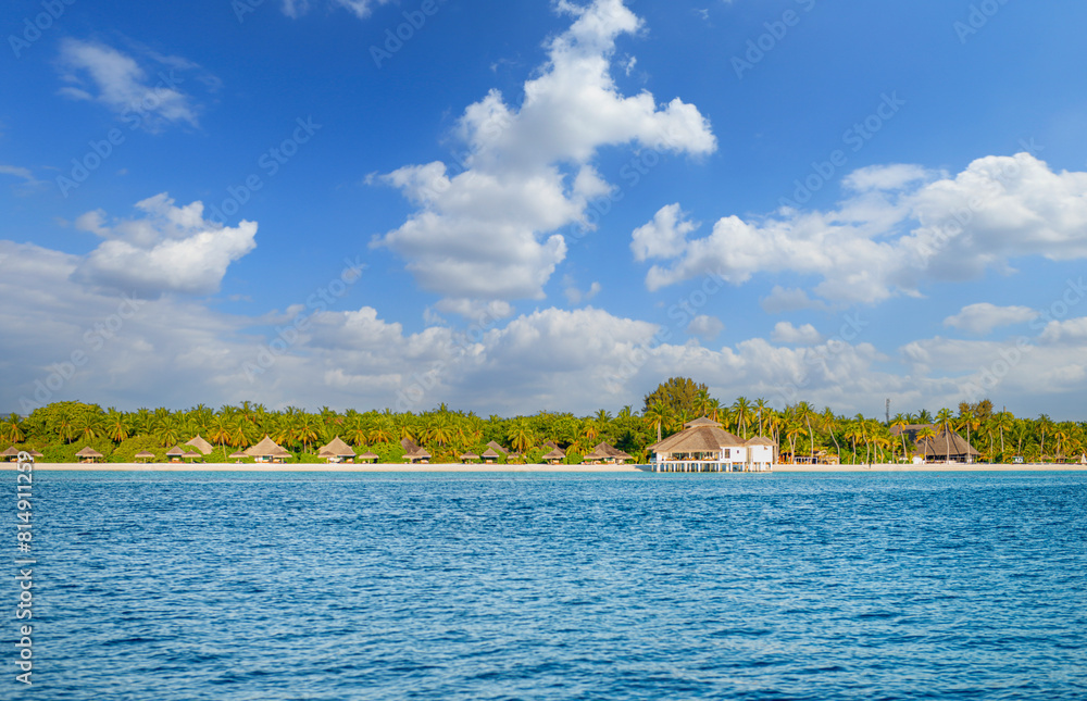 Beauty view of beach line with tall palms tree and ocean. White sand. Bright tropical summer sun and blue sky with light clouds. Wide format. Beauty view of beach line with tall palms tree and ocean. White sand. Bright tropical summer sun and blue sky with light clouds. Wide format.