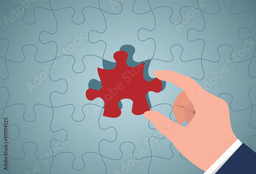 Top view flat lay of hand-holding last piece jigsaw put to place for solve problem complete mission, quiz calculation concept.