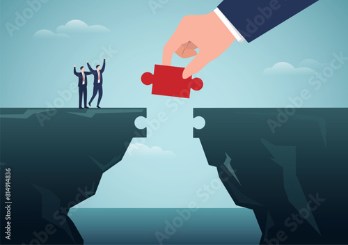 Partnership concept. A helping hand connect a jigsaw puzzle together to create a bridge.