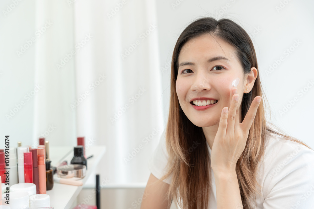 Beautiful Asian woman smile use cream for good skin. face of a healthy woman apply cream and makeup. Advertisement for skin cream, anti-wrinkle, baby face, whitening, moisturizer, tighten pores serum Beautiful Asian woman smile use cream for good skin. face of a healthy woman apply cream and makeup. Advertisement for skin cream, anti-wrinkle, baby face, whitening, moisturizer, tighten pores serum