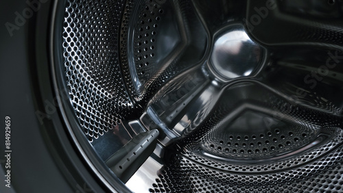 View of a stainless steel drum inside a washing machine © John_Doo78