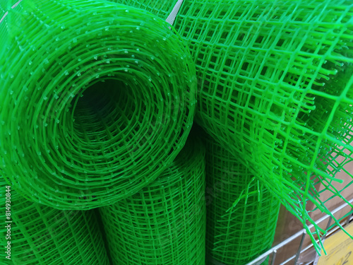 Rolls of green plastic mesh in a hardware store close up