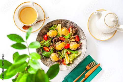 Light breakfast in a restaurant with green tea and salad