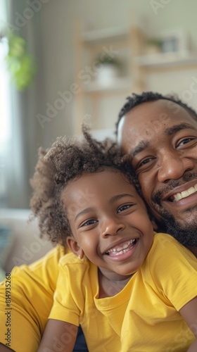A joyful moment captured between a father and his daughter both smiling broadly sharing a warm embrace in a cozy living room setting.