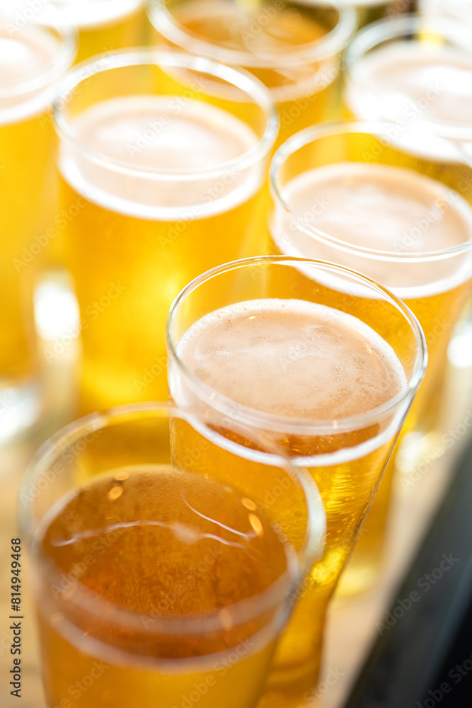 Amber lager beer in glasswares which are prepared for the party event. Refreshment drinking, close-up and selective focus. Amber lager beer in glasswares which are prepared for the party event. Refreshment drinking, close-up and selective focus.