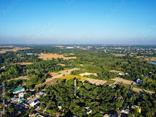 top aerial still picture of a green village with farmland in asia