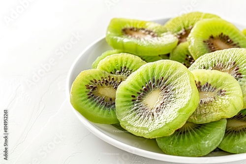 Plate with slices of kiwi on white background photo