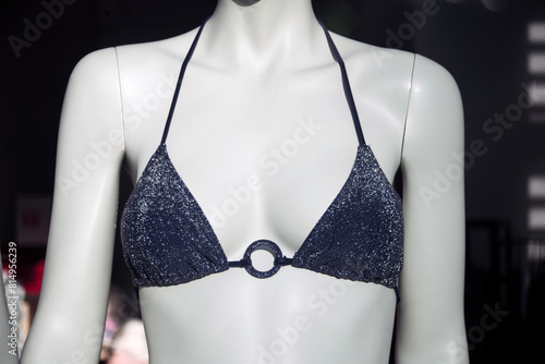 Closeup of blue bra of bikini on mannequin in a fashion store showroom