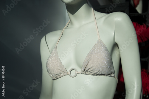 Closeup of beige bra of bikini on mannequin in a fashion store showroom