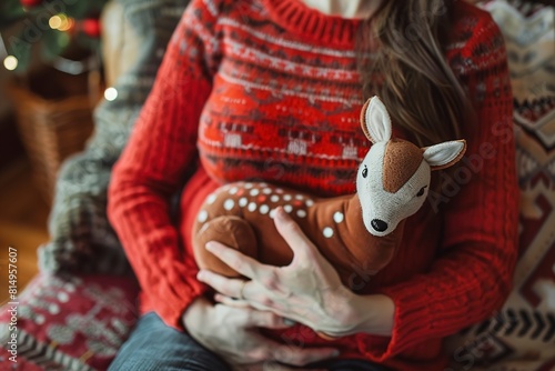 Pregnant woman with toy deer indoors closeup