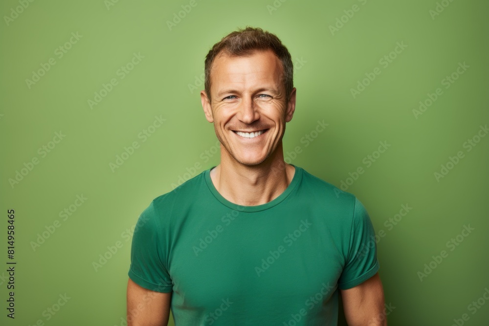 Portrait of a smiling man in his 40s smiling at the camera on pastel green background Portrait of a smiling man in his 40s smiling at the camera on pastel green background