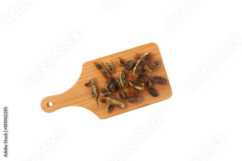 Sophora japonica on wooden board, top view. Dried plant. Fruits and seeds Cassia sophora are used in alternative therapy. Chinese Herbal Medicine