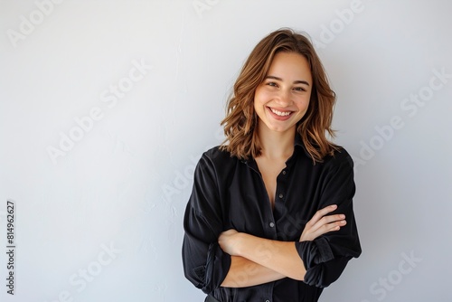 Smiling woman with arms crossed standing photo