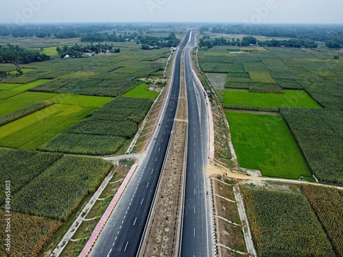 top aerial still picture of a indian village with national highway in between