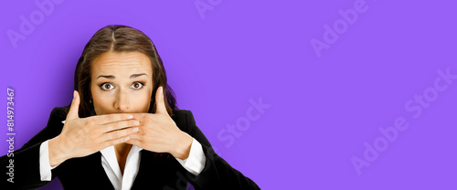 Disbelief  offers! Excited surprised, shocked, astonished businesswoman. Business woman covering mouth by her hands isolated against purple background. Wide banner image with empty slogan text ad area