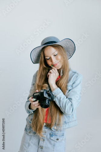 Young woman photographer looking surprised at the screen of her camera