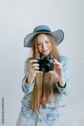 Smiling Woman Photographer with dslr Camera over studio plain background