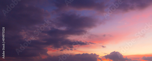 Clouds and orange sky,Real majestic sunrise sunset sky background with gentle colorful clouds without birds.Panorama, large