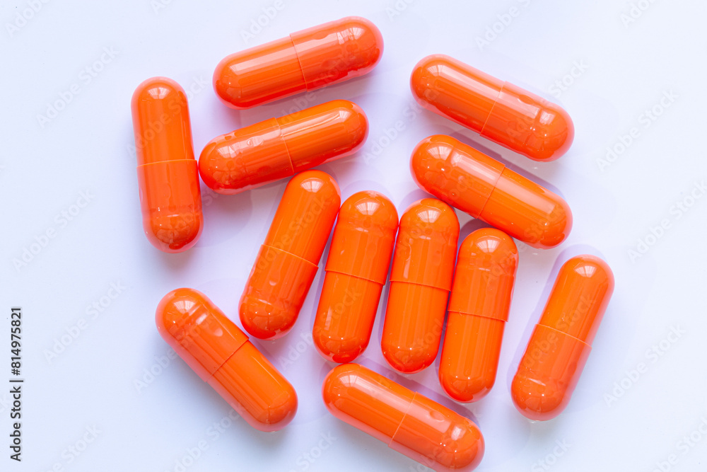 Close-up of orange pill capsules isolated on white background,Organic turmeric capsules isolated on white background Close-up of orange pill capsules isolated on white background,Organic turmeric capsules isolated on white background
