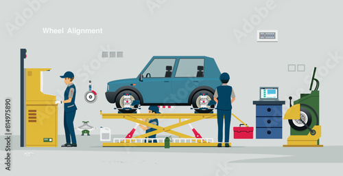 A mechanic is manipulating the wheel alignment system.