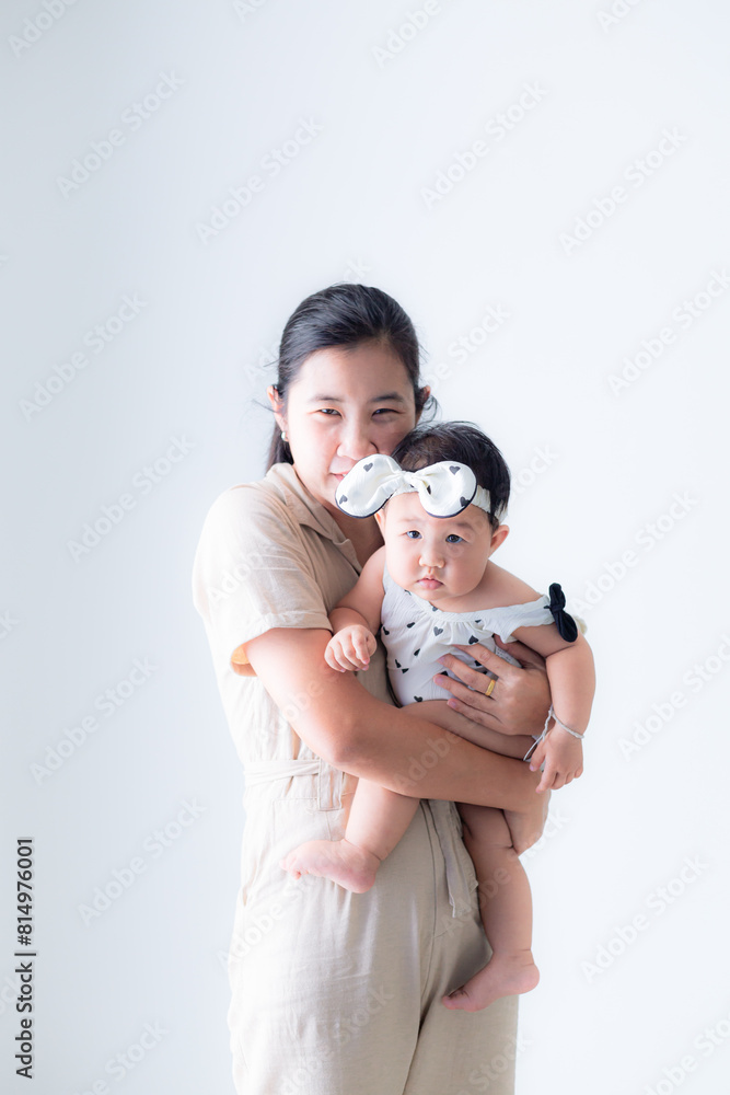 Mother and baby,Mother holding baby. Happy beautiful young mom standing in bedroom or nursery room interior in tender white and pastel colors, holding cute sweet little child and smiling. Family, love Mother and baby,Mother holding baby. Happy beautiful young mom standing in bedroom or nursery room interior in tender white and pastel colors, holding cute sweet little child and smiling. Family, love